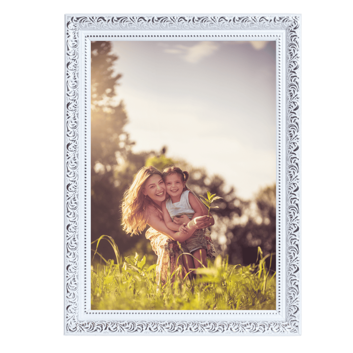 Two smiling children playfully embracing in a sunlit field.