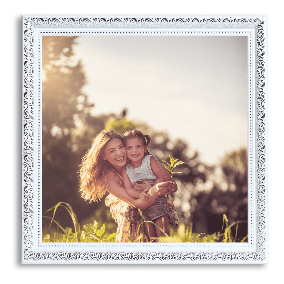 A woman holding a young girl in a sunny, grassy field.