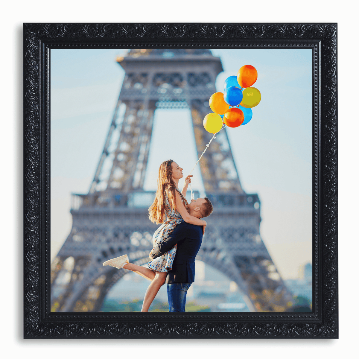 A joyful couple near the Eiffel Tower, with the woman holding colorful balloons.