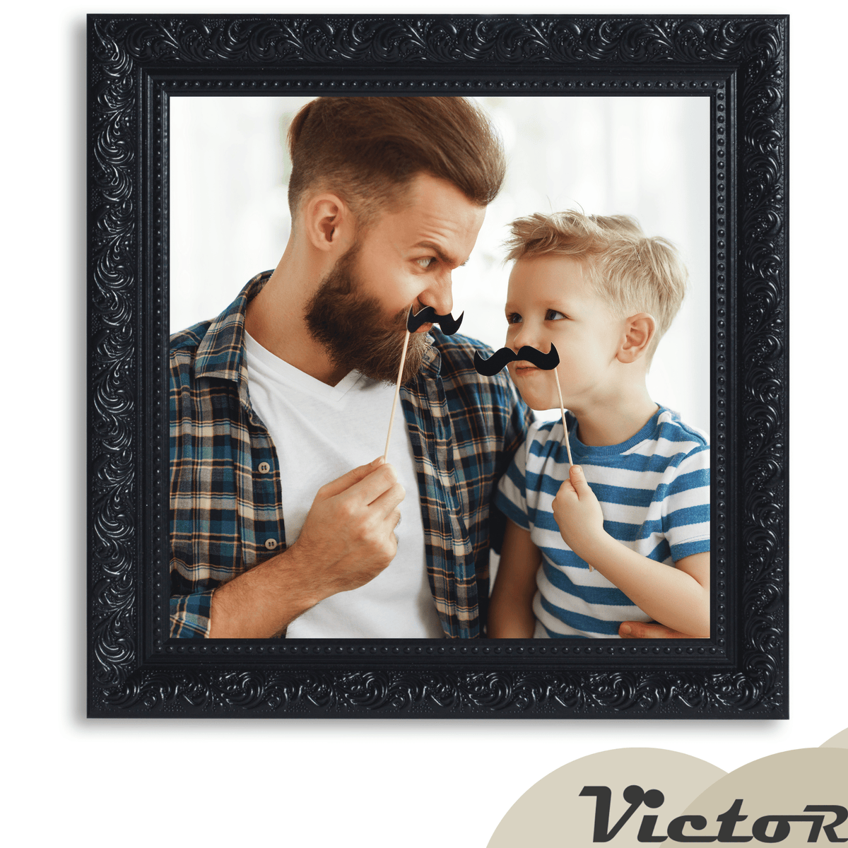 A father and son playfully holding mustache props while smiling at each other.